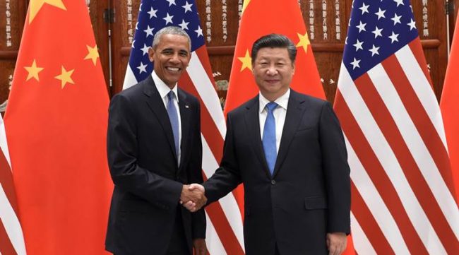 U.S. President Barack Obama, left, and Chinese President Xi Jinping pose for photographers as they shake hands before their meeting at the West Lake State Guest House in Hangzhou in eastern China's Zhejiang province Saturday, Sept. 3, 2016. (Wang Zhao/Pool Photo via AP)